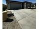 Inviting single-story home boasting a wide driveway leading to a two-car garage, complemented by desert landscaping at 18231 W Paraiso Dr, Surprise, AZ 85387