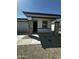 Welcoming single-story house with stone-accented pillars, a front porch, and a low-upkeep desert landscape at 18231 W Paraiso Dr, Surprise, AZ 85387