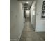 The bright hallway features tile floors, neutral paint and several doors at 18231 W Paraiso Dr, Surprise, AZ 85387