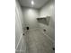 The laundry room includes tile floors, a shelf and washer/dryer hookups at 18231 W Paraiso Dr, Surprise, AZ 85387