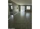 Expansive living room with sleek tile flooring, a sliding glass door, and plenty of natural light at 18231 W Paraiso Dr, Surprise, AZ 85387
