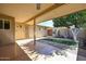 Inviting covered back patio with a view of the landscaped backyard at 18835 N Palomar Dr, Sun City West, AZ 85375