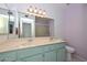 Bathroom with dual sinks, a large mirror, and a walk-in shower at 18835 N Palomar Dr, Sun City West, AZ 85375