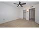 Bedroom with a ceiling fan, closet and access to another room at 18835 N Palomar Dr, Sun City West, AZ 85375