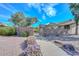 Charming gated entrance welcomes you to Palomar Estates, adorned with blooming flowers and mature trees at 18835 N Palomar Dr, Sun City West, AZ 85375