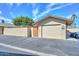 A well-maintained one car garage with a new looking blacktop driveway on a clear, sunny day at 18835 N Palomar Dr, Sun City West, AZ 85375