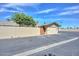 A well-maintained one car garage with a new looking blacktop driveway on a clear, sunny day at 18835 N Palomar Dr, Sun City West, AZ 85375