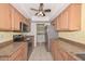 Efficient kitchen layout, stainless steel appliances and ample countertop space at 18835 N Palomar Dr, Sun City West, AZ 85375