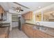 Well-lit kitchen with stainless steel appliances, granite countertops, and ample cabinet space at 18835 N Palomar Dr, Sun City West, AZ 85375