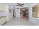 An open kitchen with tile flooring, wooden cabinets, stainless appliances and a large window at 18835 N Palomar Dr, Sun City West, AZ 85375