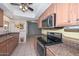 Kitchen with stainless steel appliances, tile flooring, and a ceiling fan at 18835 N Palomar Dr, Sun City West, AZ 85375