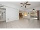 A bright living room with tile floors, a ceiling fan, and views into the kitchen at 18835 N Palomar Dr, Sun City West, AZ 85375