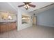 Living room view with tile flooring, sliding glass doors, and a breakfast bar leading to the kitchen at 18835 N Palomar Dr, Sun City West, AZ 85375