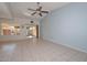 Open living room with a ceiling fan and sliding glass doors to the backyard at 18835 N Palomar Dr, Sun City West, AZ 85375