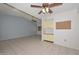 Spacious living room with tile floors, neutral walls, and built-in storage cabinets at 18835 N Palomar Dr, Sun City West, AZ 85375