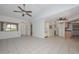Spacious living room featuring tile floors, bright light, and ceiling fans at 18835 N Palomar Dr, Sun City West, AZ 85375