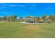 A beautiful, sprawling park with well-manicured green grass, a gazebo, and trees at 18835 N Palomar Dr, Sun City West, AZ 85375
