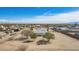 Expansive aerial view of property featuring a white roofed home and desert landscaping in sunny Arizona at 2038 S 221St Ave, Buckeye, AZ 85326