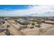 Aerial view of desert property featuring a white roofed home with solar panels and ample land at 2038 S 221St Ave, Buckeye, AZ 85326