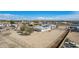 Aerial view of the home featuring a solar panel, spacious yard, and a fenced perimeter at 2038 S 221St Ave, Buckeye, AZ 85326