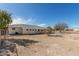 Large backyard with a covered patio and a chain link fence for secure outdoor enjoyment at 2038 S 221St Ave, Buckeye, AZ 85326