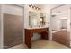 A well-lit bathroom with a double vanity and a view through to the adjacent rooms at 2038 S 221St Ave, Buckeye, AZ 85326