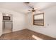 A bright bedroom featuring wood look flooring, ceiling fan, and window at 2038 S 221St Ave, Buckeye, AZ 85326