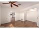 Bright bedroom with wood-look flooring and an open closet with wooden rod at 2038 S 221St Ave, Buckeye, AZ 85326