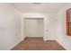 Cozy bedroom with wood-look floors, open closet, and a bright window at 2038 S 221St Ave, Buckeye, AZ 85326