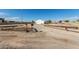 Long dirt driveway leading to the house and garage under a clear sky at 2038 S 221St Ave, Buckeye, AZ 85326