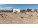 Exterior view of home, featuring a large lot and dirt yard at 2038 S 221St Ave, Buckeye, AZ 85326