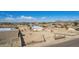 Wide aerial shot of home with white exterior, solar panels, large yard, and mountain views at 2038 S 221St Ave, Buckeye, AZ 85326
