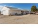 View of the detached garage, the main house, and the chain link fenced in yard at 2038 S 221St Ave, Buckeye, AZ 85326