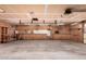 Large garage space boasts built-in shelving, ample storage and a workspace at 2038 S 221St Ave, Buckeye, AZ 85326