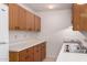 A kitchen featuring wooden cabinetry, white countertops, and essential appliances at 2038 S 221St Ave, Buckeye, AZ 85326
