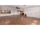 Spacious living room featuring modern wood flooring, ceiling fan, and access to the kitchen at 2038 S 221St Ave, Buckeye, AZ 85326