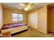 Bedroom featuring carpet, tan walls, ceiling fan, window with blinds and a double bed at 21593 E Nightingale Ct, Queen Creek, AZ 85142