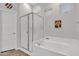 Bathroom featuring a glass-enclosed shower, tub, sunflower decor and ample natural light at 2213 E Constance Way, Phoenix, AZ 85042