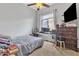 Functional bedroom with a large window, desk setup, and a cozy bed at 2213 E Constance Way, Phoenix, AZ 85042
