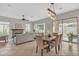 Bright dining area featuring an open floorplan to living and exterior spaces at 2213 E Constance Way, Phoenix, AZ 85042