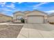 Inviting single-story home boasting a two-car garage, complemented by stone accents and low-maintenance landscaping at 2213 E Constance Way, Phoenix, AZ 85042