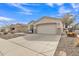Charming single-story home featuring a two-car garage, stone accents, and a well-maintained desert landscape at 2213 E Constance Way, Phoenix, AZ 85042