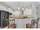 Eat-in kitchen featuring counter seating, granite countertops, white cabinets, and stainless steel appliances at 2213 E Constance Way, Phoenix, AZ 85042