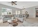 Open-concept living area with tile floors, comfortable seating, and access to the backyard at 2213 E Constance Way, Phoenix, AZ 85042