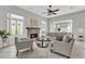 Bright living room with stone fireplace, tile floors, and abundant natural light at 2213 E Constance Way, Phoenix, AZ 85042