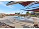 Community pool and splash pad area with lounge chairs and shaded seating at 2254 E Tomahawk Dr, Gilbert, AZ 85298