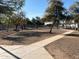 Large fenced dog park with picnic benches and shade canopies for owners in a community setting at 255 S Kyrene Rd # 115, Chandler, AZ 85226