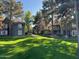 Exterior shot of condo complex with lush lawn and mature trees at 255 S Kyrene Rd # 115, Chandler, AZ 85226