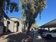 Condo complex featuring mature shade trees and covered parking spaces for residents at 255 S Kyrene Rd # 115, Chandler, AZ 85226