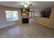 Open-concept living room featuring a fireplace and views into the kitchen at 255 S Kyrene Rd # 115, Chandler, AZ 85226